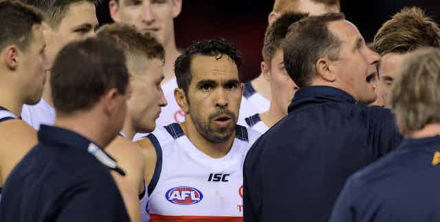 Eddie Betts of the Crows listens to coach Don Pyke of the Crows (right) at the first quarter break during the Round 21 AFL mens match between the Essendon Bombers and the Adelaide Crows at Etihad Stadium in Melbourne, Saturday, August 12, 2017.