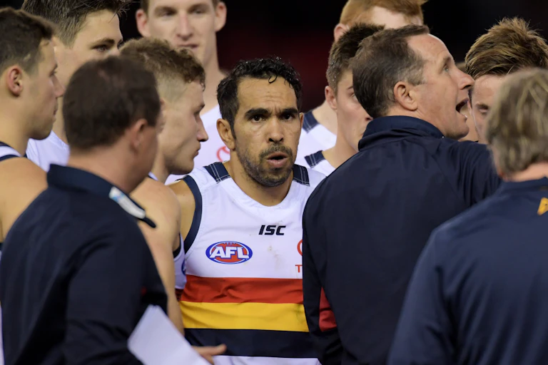 Eddie Betts of the Crows listens to coach Don Pyke of the Crows (right) at the first quarter break during the Round 21 AFL mens match between the Essendon Bombers and the Adelaide Crows at Etihad Stadium in Melbourne, Saturday, August 12, 2017.