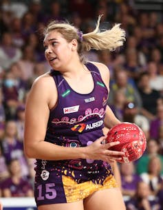 Indigenous person Donnell Wallam playing netball.