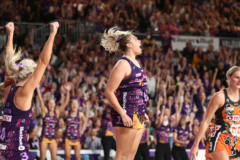 A First Nations netballer Donnell Wallam celebrates on court during a match.