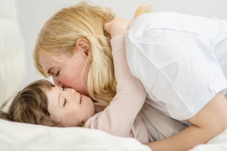 adult woman hugs small child