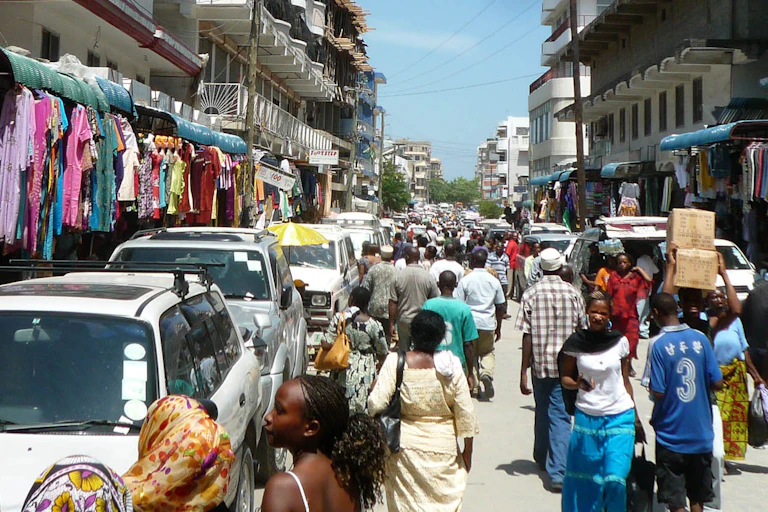 Men and women in a busy street selling