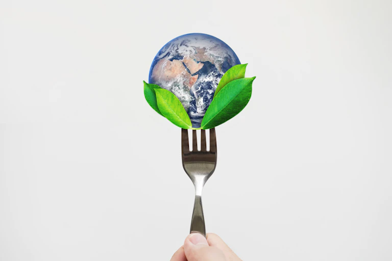 concept image of fork holding planet earth