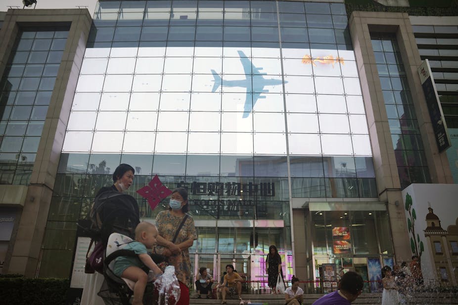China's show of strength over Taiwan being transmitted live in a shopping mall in Beijing. 