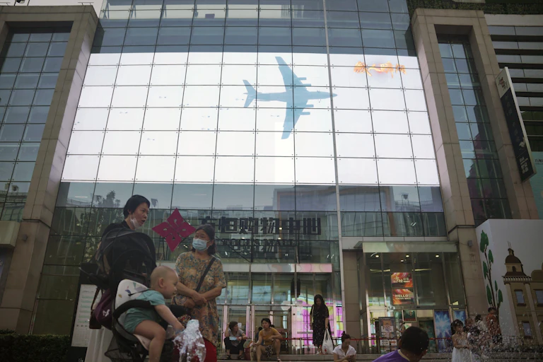 China's show of strength over Taiwan being transmitted live in a shopping mall in Beijing.