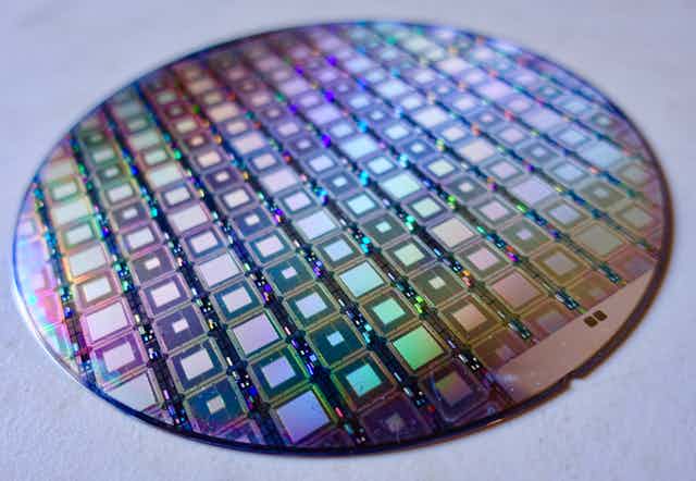 A disc covered in iridescent squares.