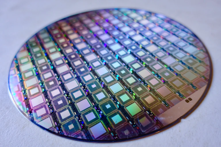 A disc covered in iridescent squares.