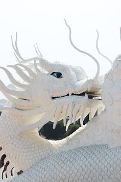 Pure white dragon looking backward.