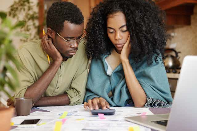 Man and woman with calculator and paperwork