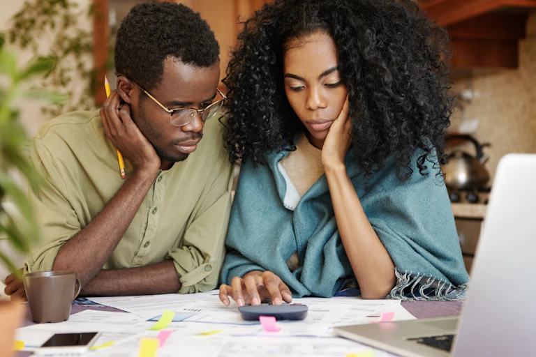 Man and woman with calculator and paperwork