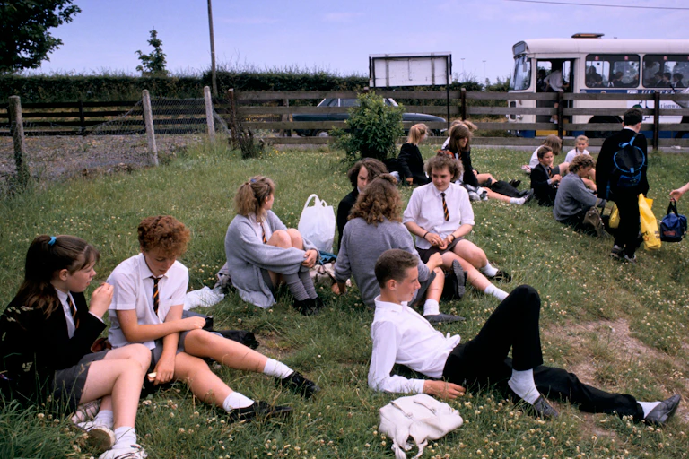 Schoolchildren sat on grass