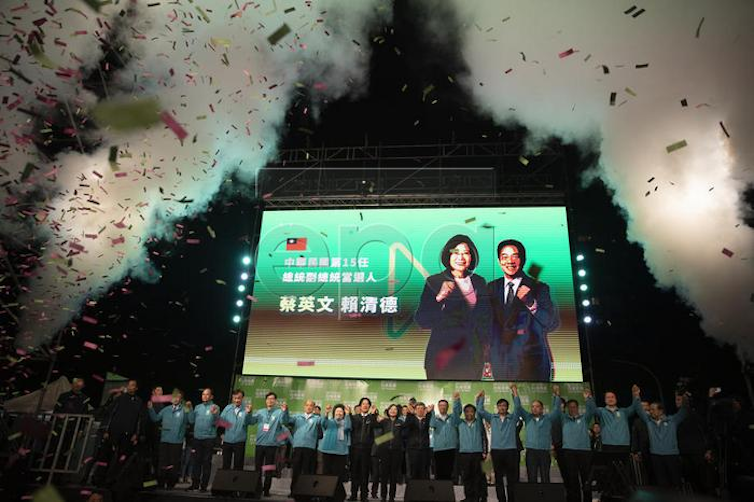 Tsai Ing-wen and her supporters celebrate victory in the 202 presidential elections. Tsai is seen on a big screen above.
