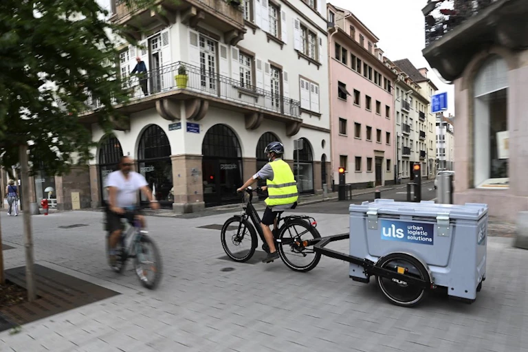 A man on a cargo bike in a town