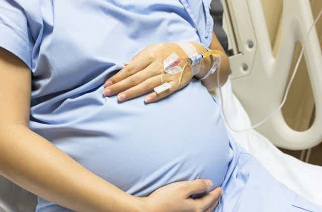 pregnant person in hospital bed