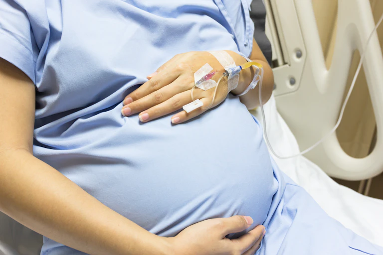pregnant person in hospital bed