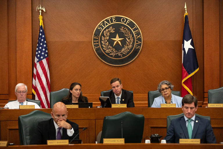People sitting in the Texas State Capitol