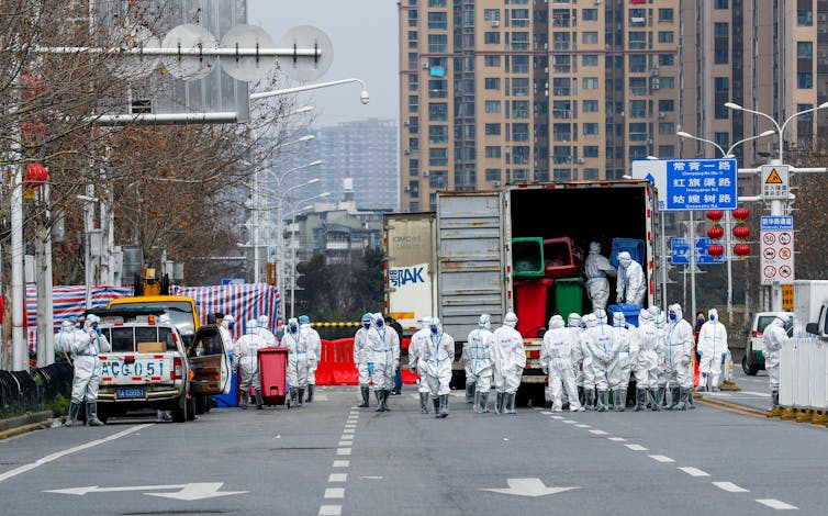 A team of people doing disinfecting work at the Huanan Wholesale Seafood Market, March 2020