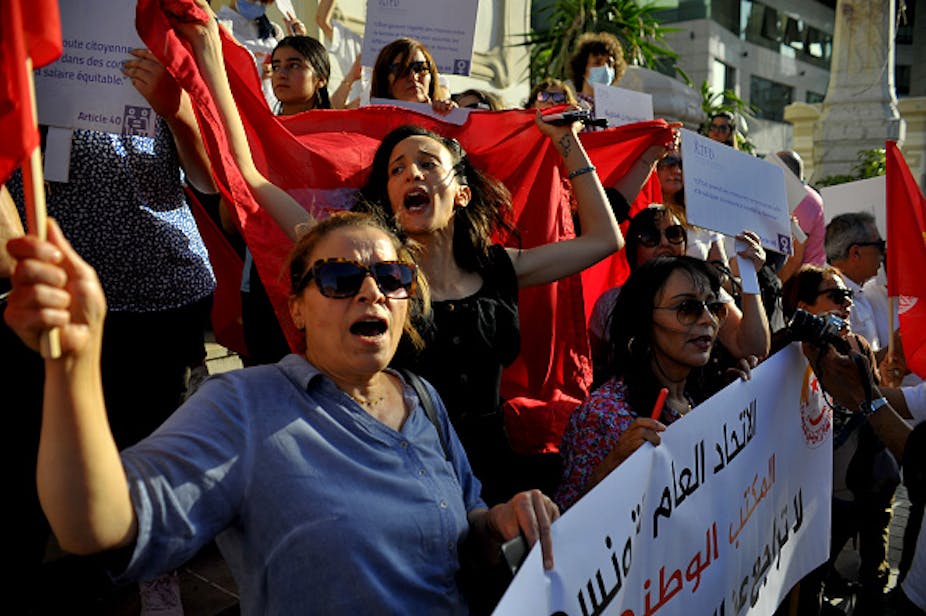 A group of women holding banners outdoors