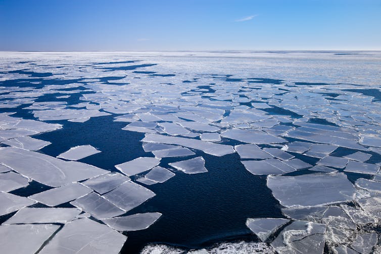 Blocks of melting sea ice revealing a deep blue sea.