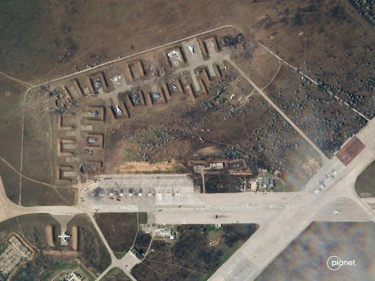 A satellite photo of an air base with blast marks.