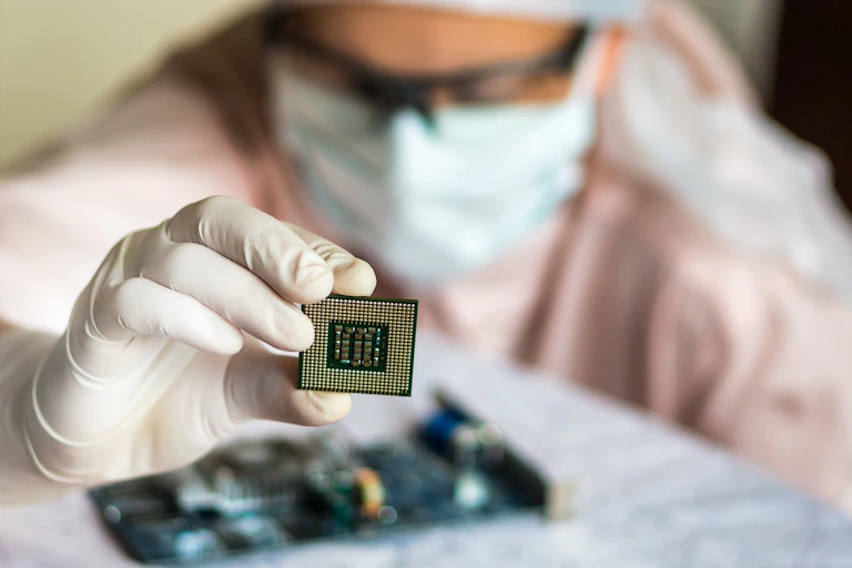 Scientist holding up microchip