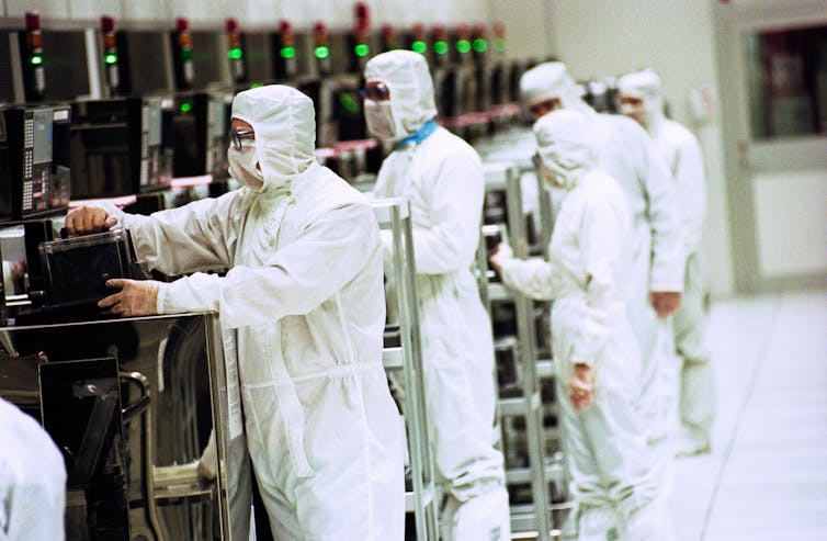 Factory workers on a semiconductor production line in Wales