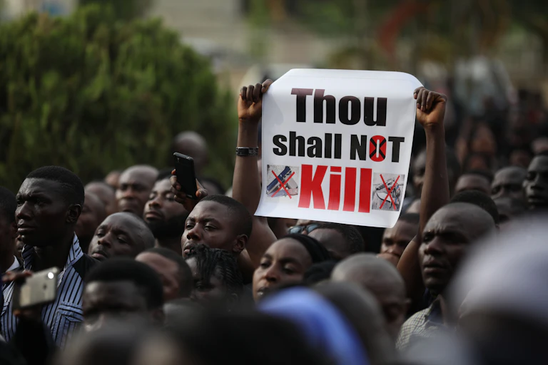 People carrying banners in protest.