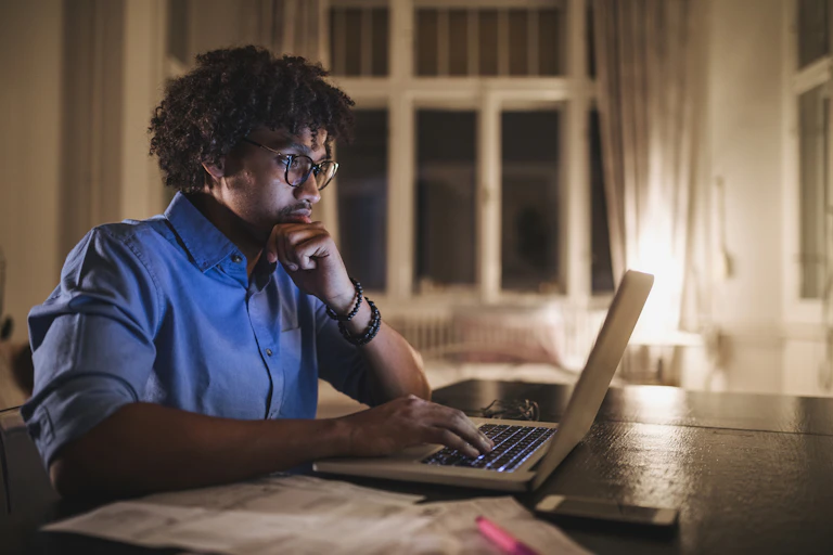 Young man sitting at a desk working on a computer