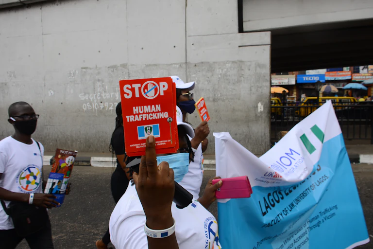 Man and woman holding placards