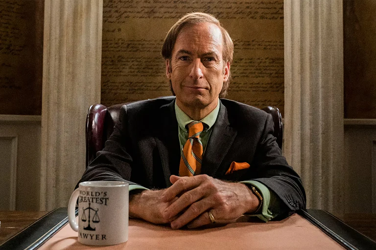 Actor Bob Odenkirk as the character Saul Goodman sits at his desk.