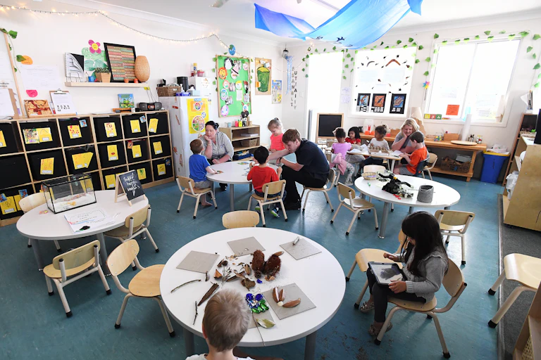 Children and educators in a daycare classroom.