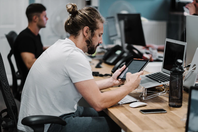 Man at desk using tablet