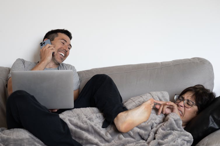 Woman smells man's smelly feet