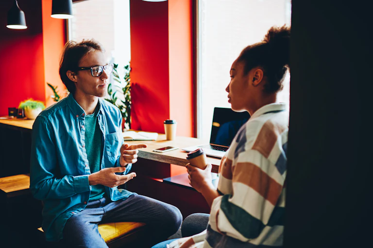 A young man and woman talking.