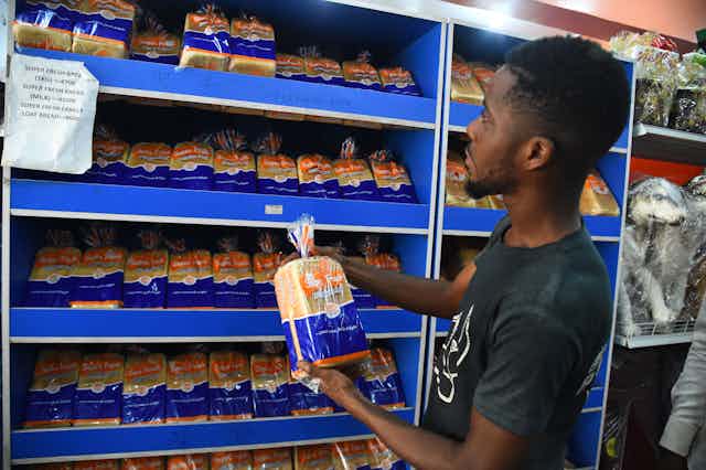 A man holds bread being sold at a high price in a supermarket at Ketu in Lagos, Nigeria's commercial capital on March 15, 2022.