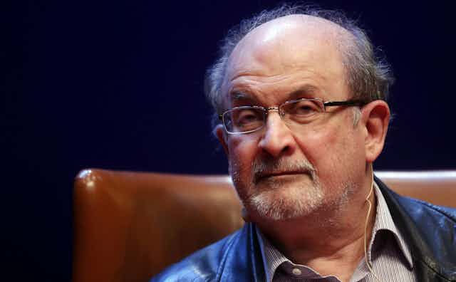 Close-up photo of Salman Rushdie sitting in a leather chair