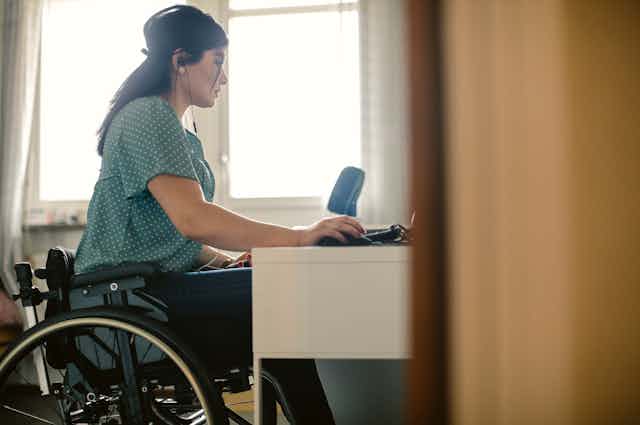woman in wheelchair at desk