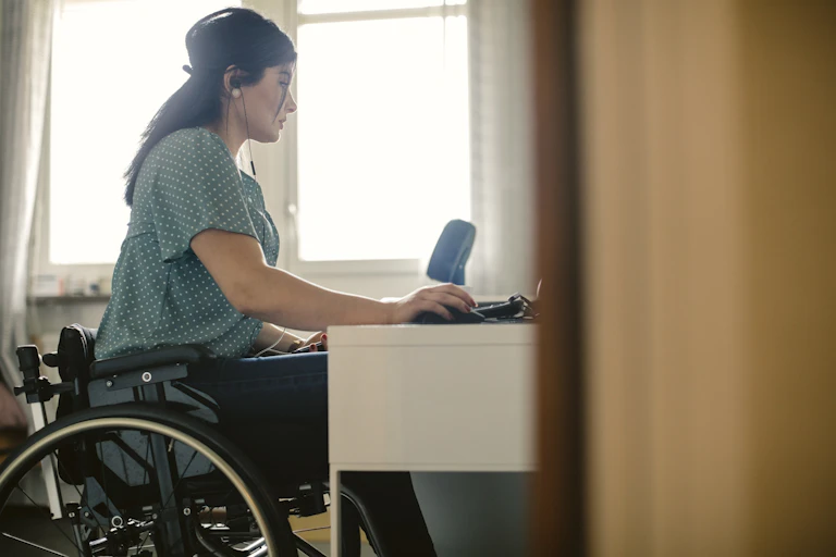 woman in wheelchair at desk