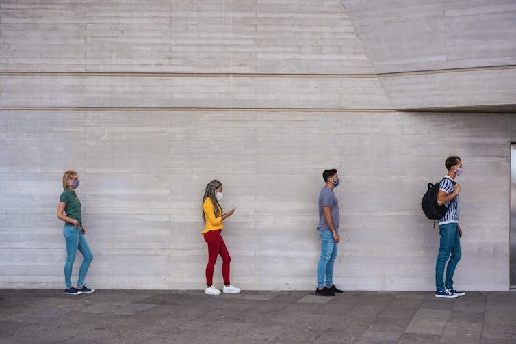 Students seen in a line wearing face masks.