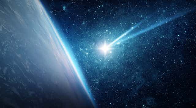 View of a planet's surface from space with a bright meteor heading towards it