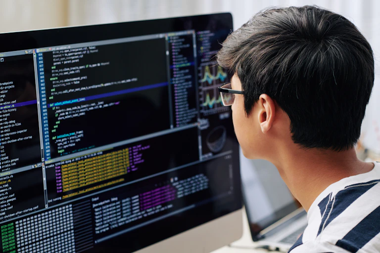 A youth seen looking at a screen.