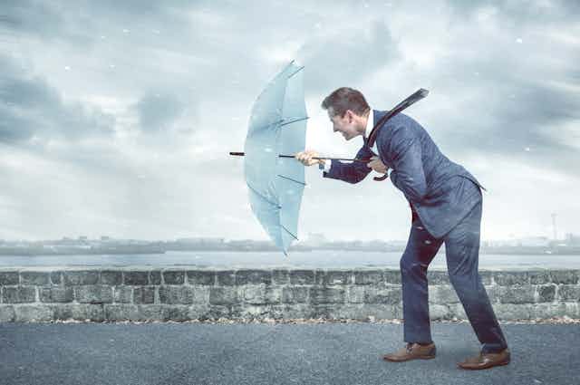 Man in suit with umbrella, bad weather