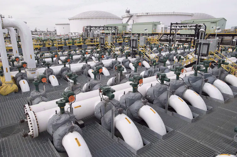 A large room with industrial-sized pipes running along the length of it