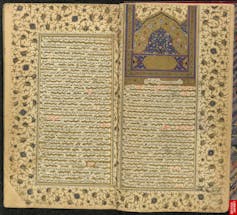 An Islamic manuscript etched with a floral margin and etched predominantly in gold, blue and pink colors.