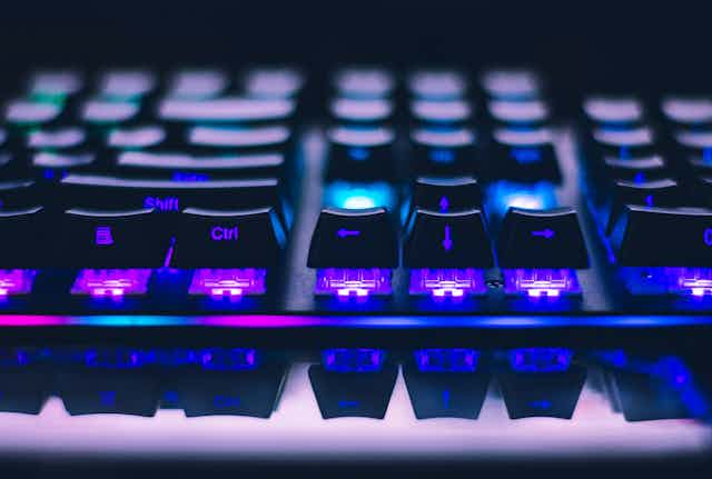 Close-up photo of an illuminated gaming keyboard.