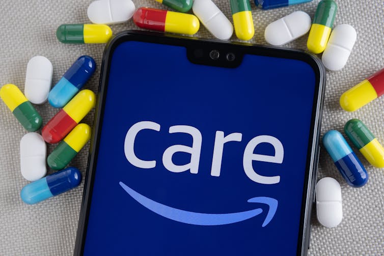 Smartphone with Amazon Care logo, surrounded by pills.