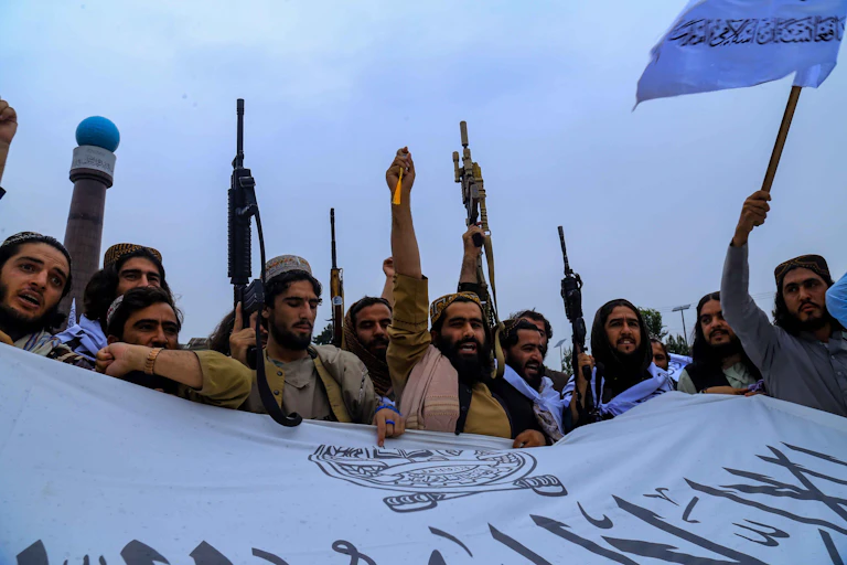 A group of Afghan men celebrate.