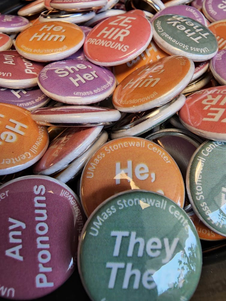 An assortment of buttons that feature a variety of different pronouns.