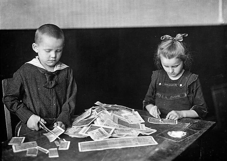 Germany children playing with banknotes rendered valueless through hyperinflation, circa 1919.