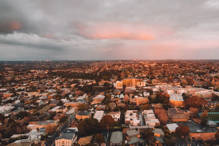 Aerial view of urban landscape under cloudy sky